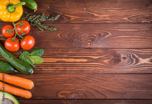 Fresh organic vegetables. Pepper, tomato, avocado, on wooden background. Healthy food and healthy life concept. Top view