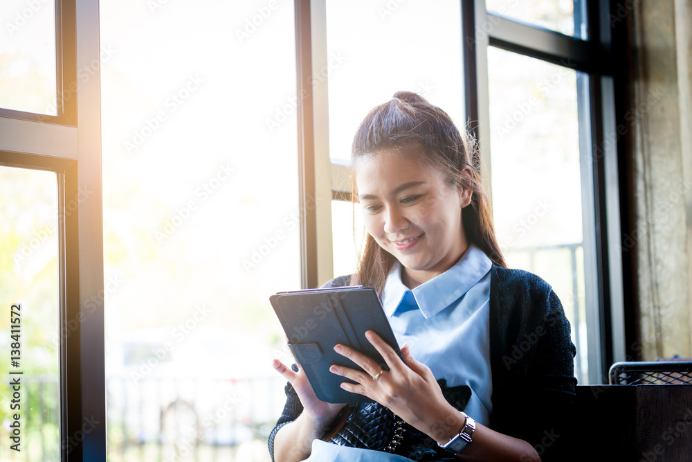 Young woman using tablet in coffee shop Young woman using tablet in coffee shop