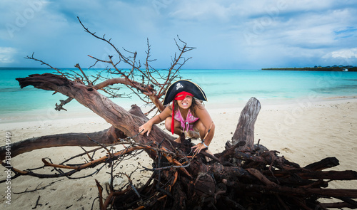 Photography Gorgeous amazing funny, angry little girl pirate sitting on old dead tree at the