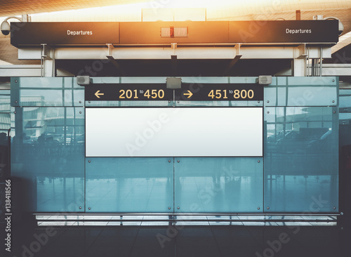 Blank electronic departures and arrival informational billboard with clean space for publicity content or text message, narrow advertising mock up in interior, public commercial board in airport hall photo