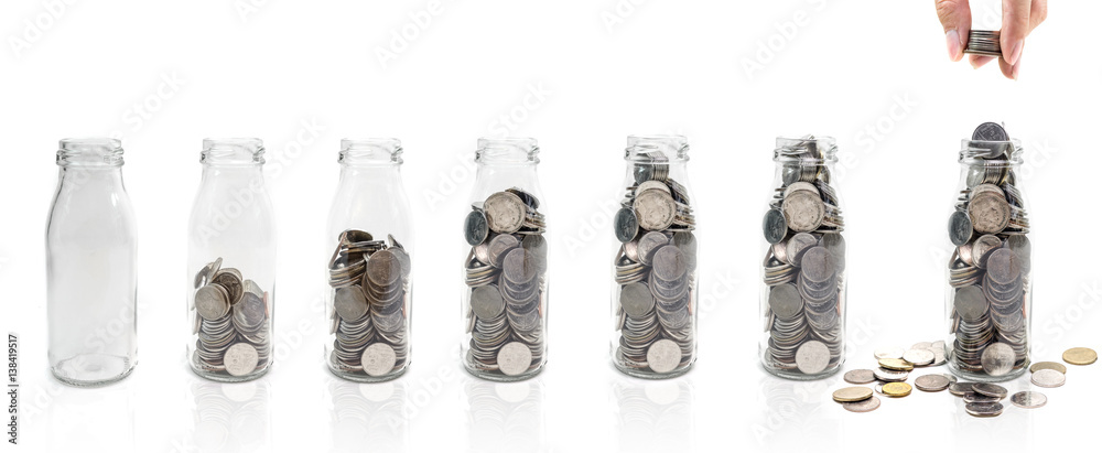 Saving money concept of collecting coins in glass bottle Isolated on white background. copy space. Saving money concept of collecting coins in glass bottle Isolated on white background. copy space.