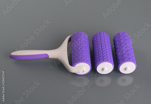 Pattern embosser with handle on gray background photo