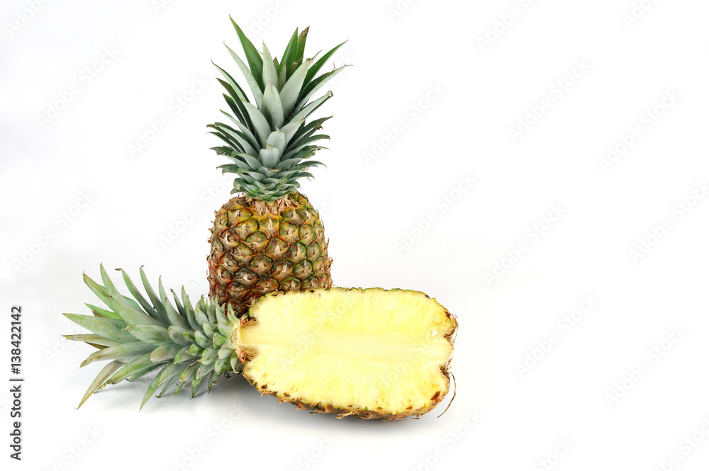 whole pineapple and cut in half isolated on white background whole pineapple and cut in half isolated on white background