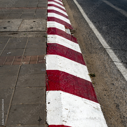 Red and white concrete road curb © santagig
