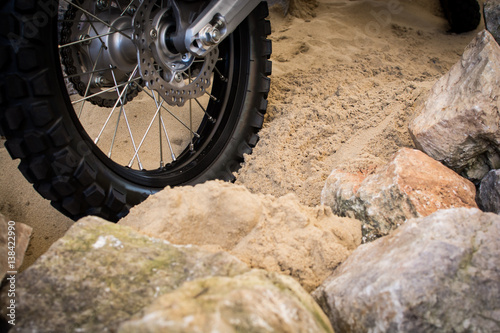Close up Motocross wheel on rock and sand