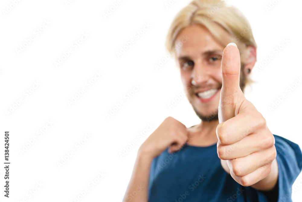Content young man giving thumb up Content young man giving thumb up