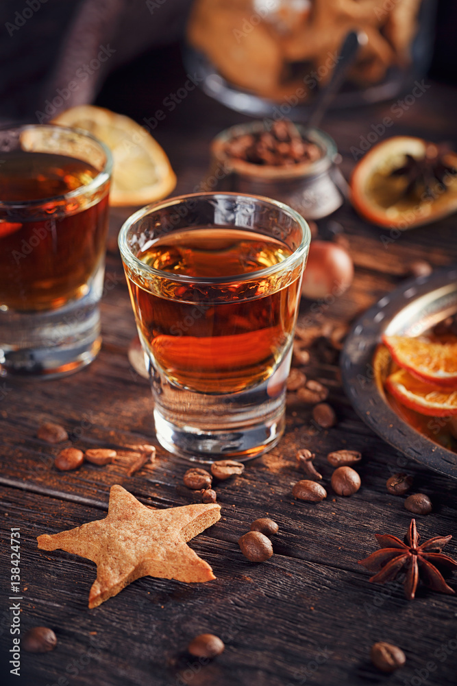 Whiskey or liqueur, cookies, spices and decorations on wooden background. Whiskey or liqueur, cookies, spices and decorations on wooden background.