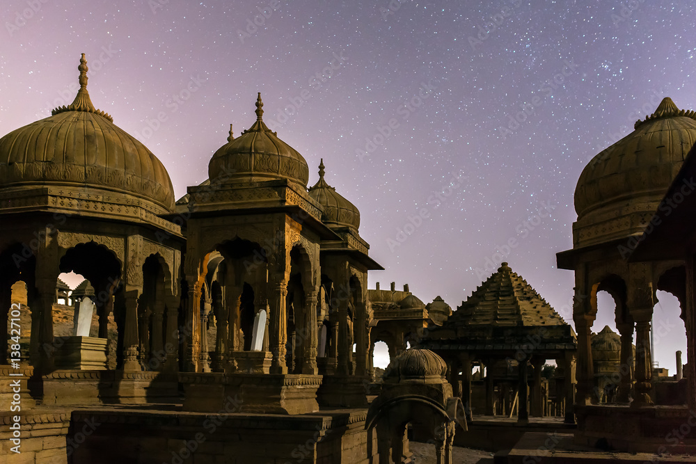 The royal cenotaphs of historic rulers, also known as Jaisalmer Chhatris, at Bada Bagh in Jaisalmer, Rajasthan, India. Night shot of ruins with stars