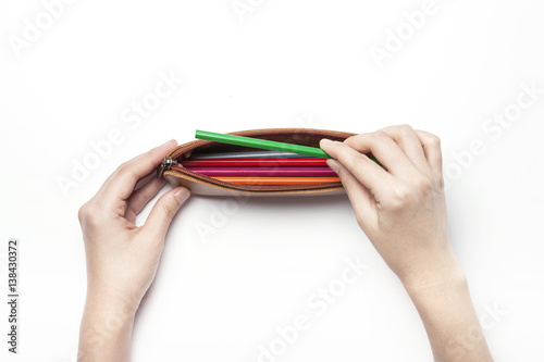 woman hand hold a color pencil isolated white