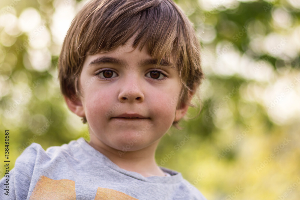 Portrait of a little boy playing in a park in a sunset Portrait of a little boy playing in a park in a sunset