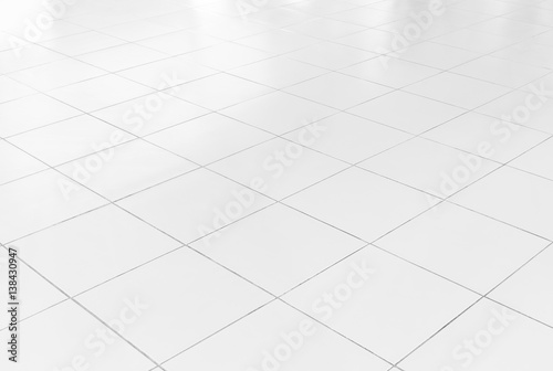 White tile floor background in perspective view. Clean, shiny, symmetry with grid line texture. For decoration in bathroom, kitchen and laundry room. And empty or copy space for product display also.