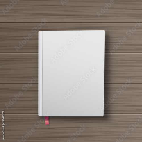 Realistic book with white cover on a wooden table. Mock Up of bo