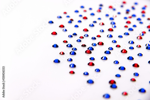 Rhinestones blue and red on a white background acrylic.