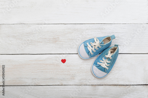 Blue shoes for a little boy on a wooden background. flat lay
