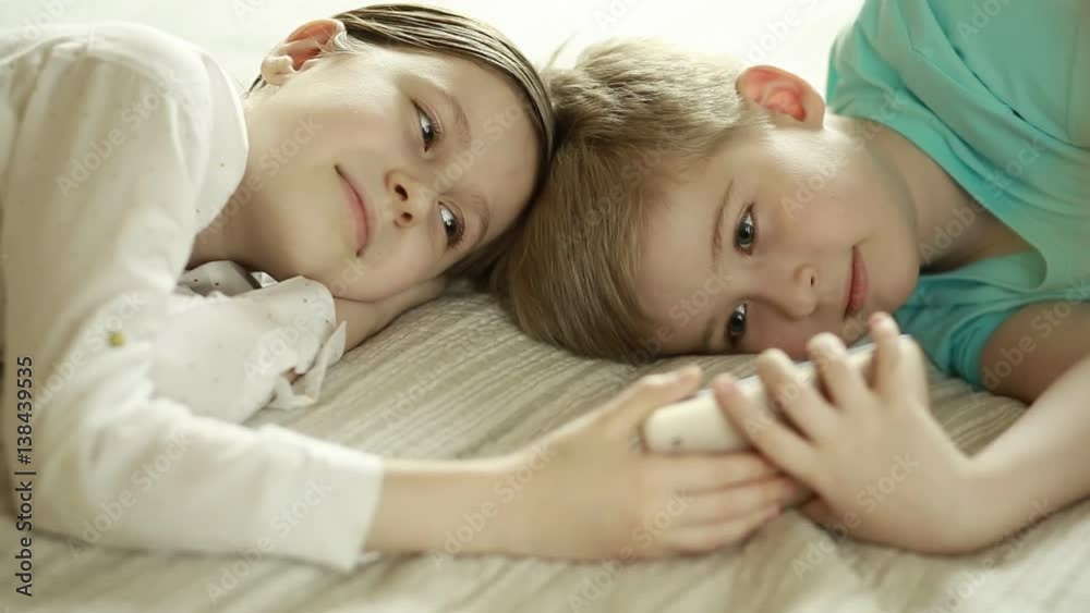  Child boy and girl playing with smart phone