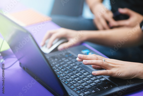 Woman working at home office hand on keyboard close up.