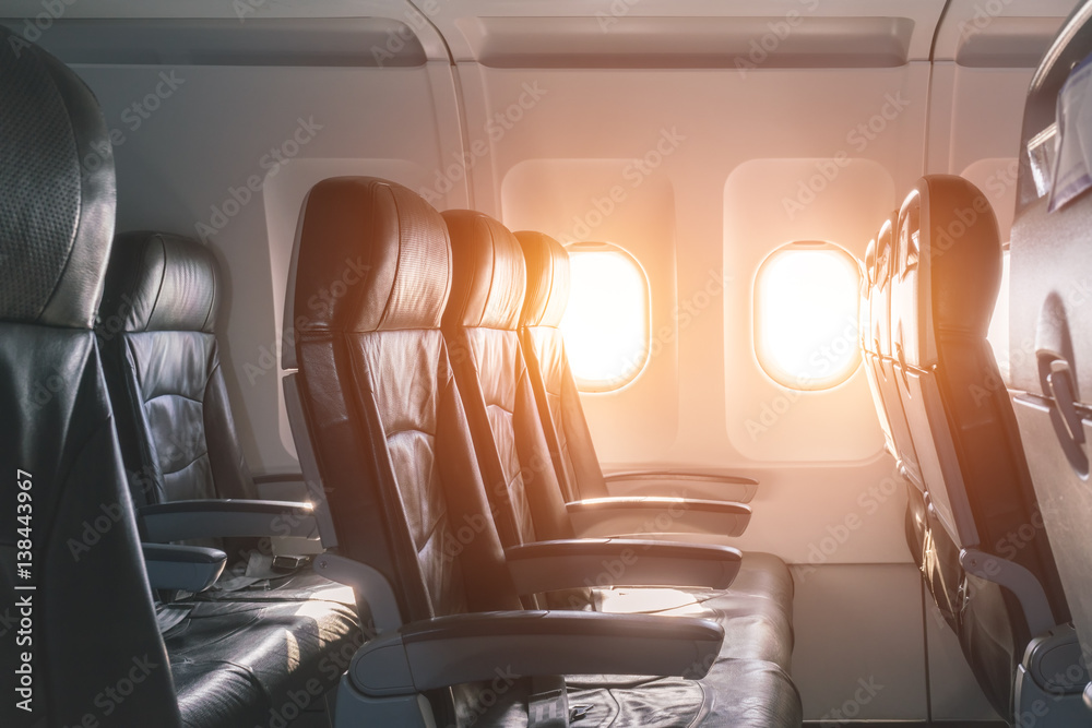 Fototapeta premium Empty seats and window inside an aircraft
