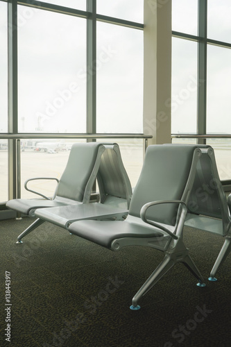 waiting area at airport terminal with empty chairs