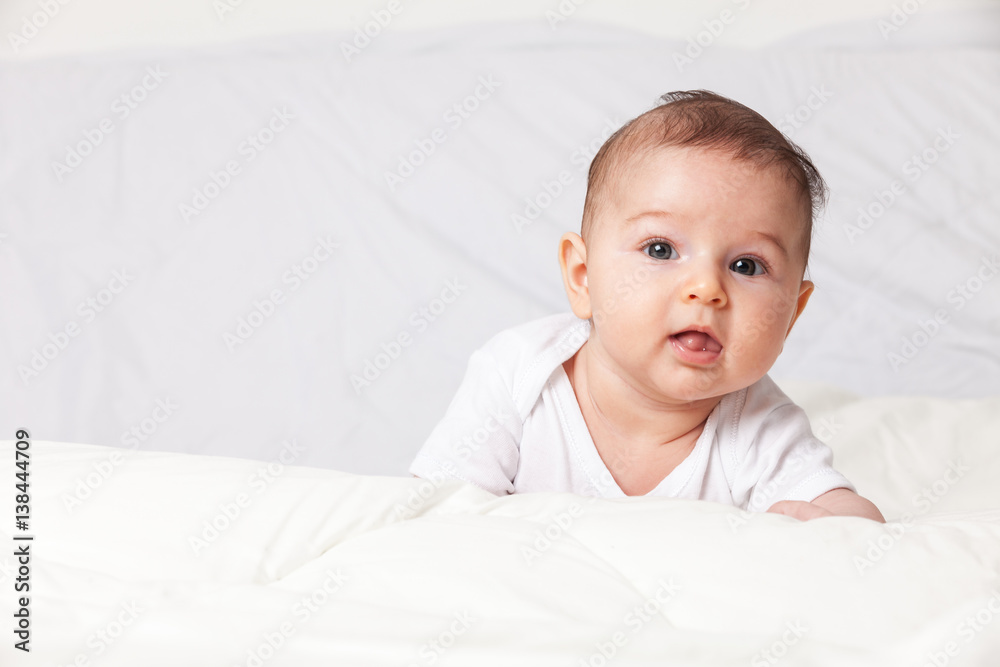 Baby girl is lying on bed Baby girl is lying on bed