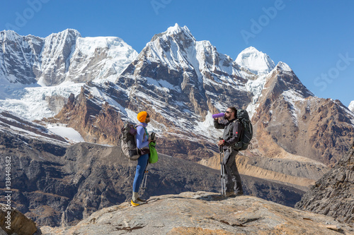 Two Hikers staying on top of Rock and relaxing