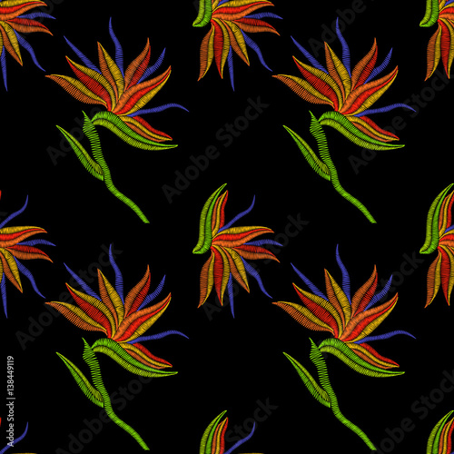 Embroidery Bird of Paradise flowers, tropical Strelitzia seamless pattern. Vector fashion ornamental floral print on black background for fabric traditional folk decoration.