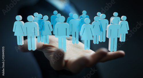 Businessman holding 3D rendering group of people in his hand