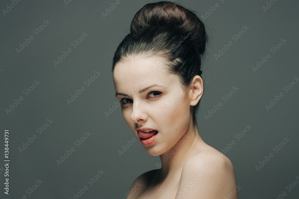 brunette on a gray background, beautiful hairdress brunette on a gray background, beautiful hairdress