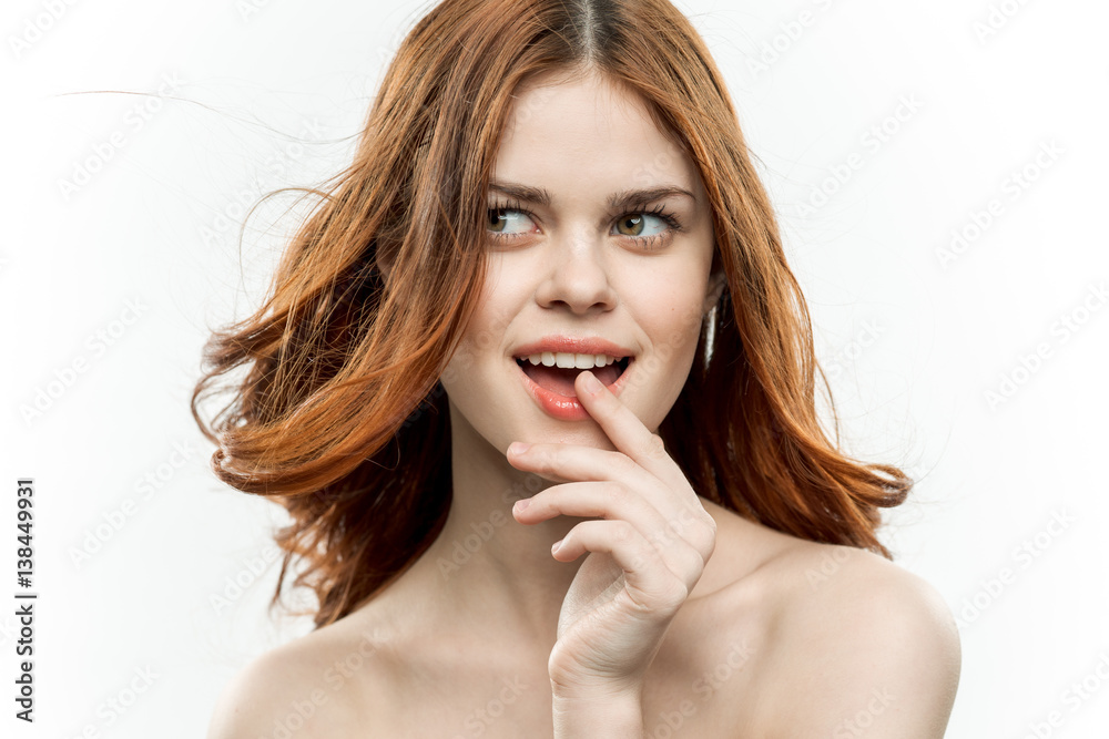 beautiful woman looks away, finger near lips beautiful woman looks away, finger near lips