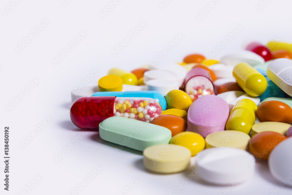 Multicolored pills and tablets on white background Multicolored pills and tablets on white background