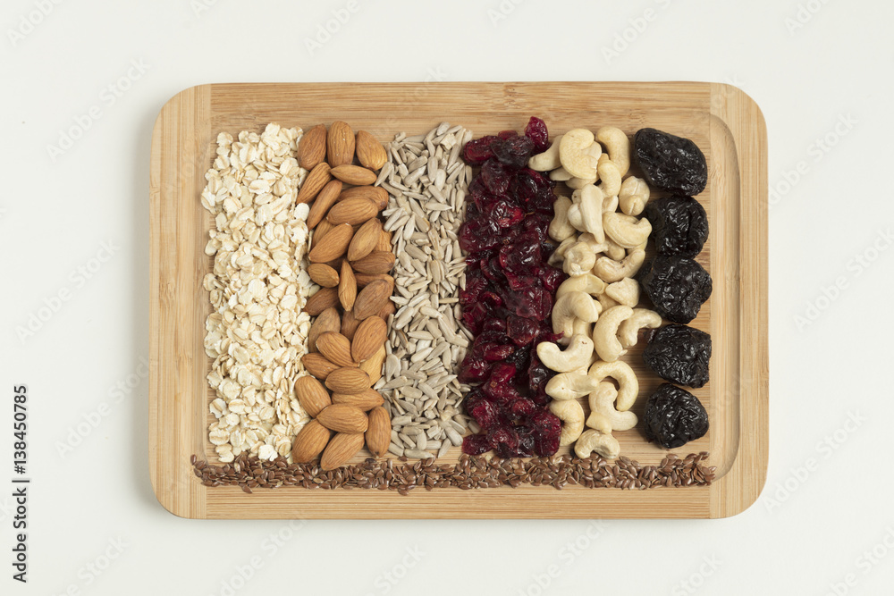 Granola materials served on wooden plate top view Granola materials served on wooden plate top view