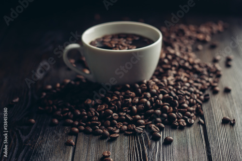 cup with a drink and coffee beans around