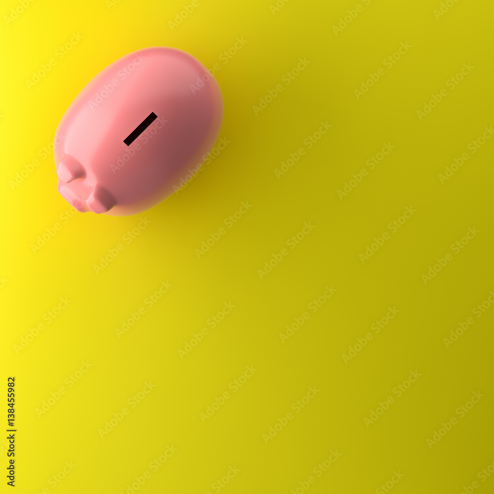 TOP VIEW OF PIGGY BANK ON YELLOW BACKGROUND