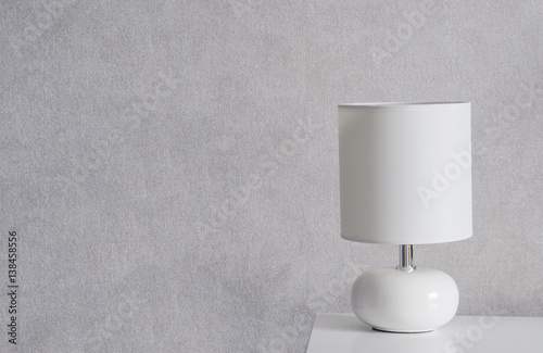 White Lamp on a commode. Grey background. Home concept