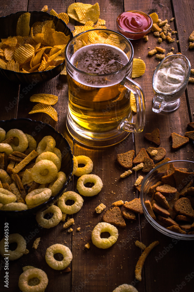 Beer and snacks on the wooden background