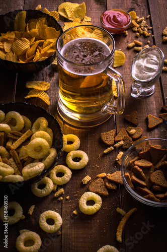 Beer and snacks on the wooden background