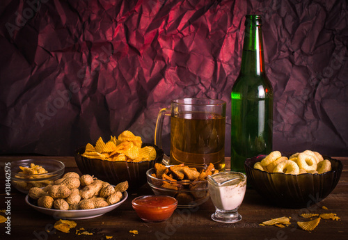 Beer and snacks on the wooden background