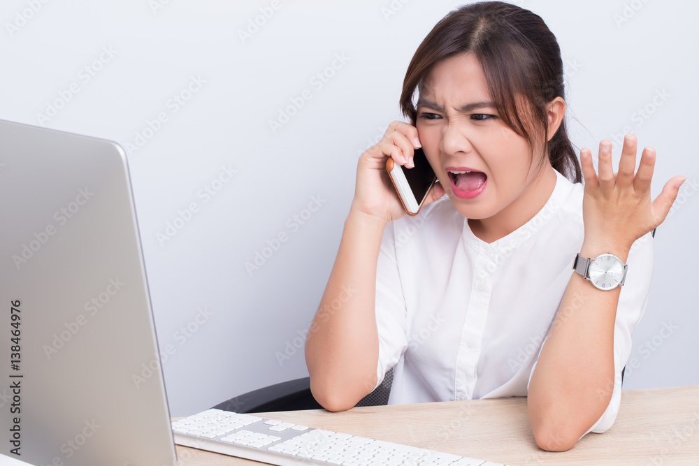 Angry woman use the smartphone at the office Angry woman use the smartphone at the office