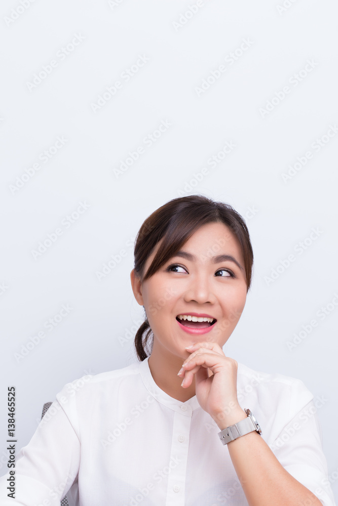 Asian woman pointing to the copy space isolated on blue background Asian woman pointing to the copy space isolated on blue background