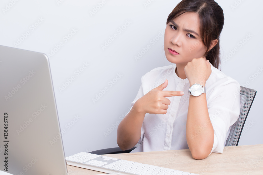 Angry woman checking time at office Angry woman checking time at office
