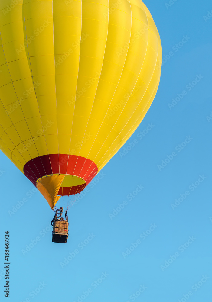 Fototapeta premium Yellow hot air balloon flying on blue sky