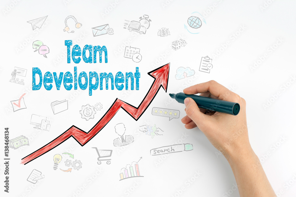 Hand with marker writing - Team Development, Business Concept