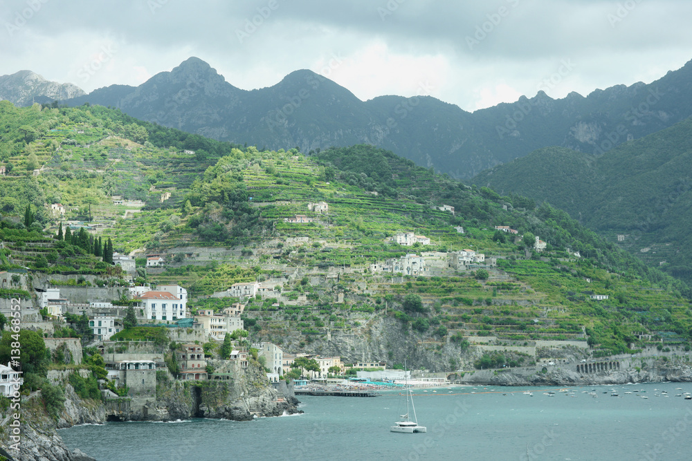 View of the rocky coast of the Gulf of Salerno and the mountain range in the town of Amalfi, Italy.