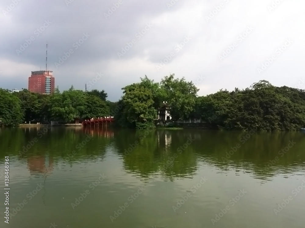 A city along a river in Vietnam, surrounded by tree and wild nature A city along a river in Vietnam, surrounded by tree and wild nature