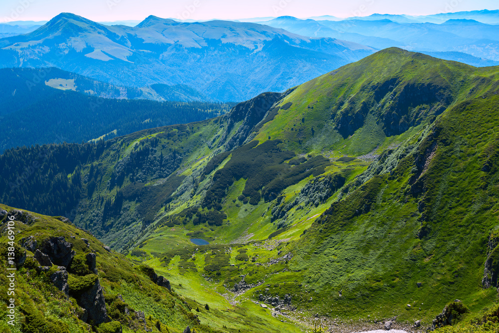 Amazing mountain gorge among the green alpine meadows