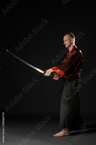 Young man in chinese costume with sword