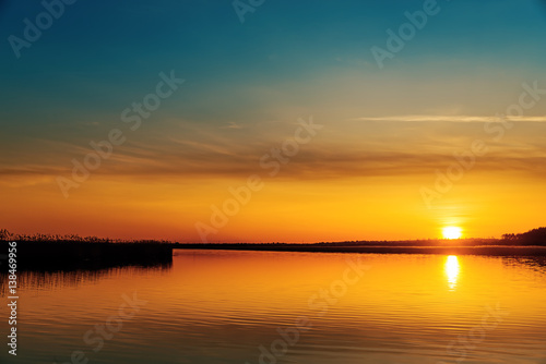 orange sunset over river © Mykola Mazuryk
