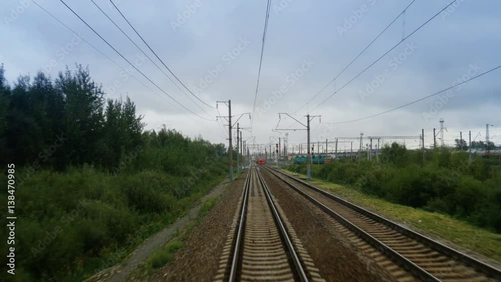 Train passing through countryside, moving railroad tracks in day Train passing through countryside, moving railroad tracks in day