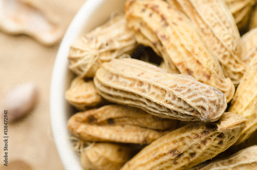 Boiled peanuts or groundnuts in a bowl on wooden background ready to eating Boiled peanuts or groundnuts in a bowl on wooden background ready to eating