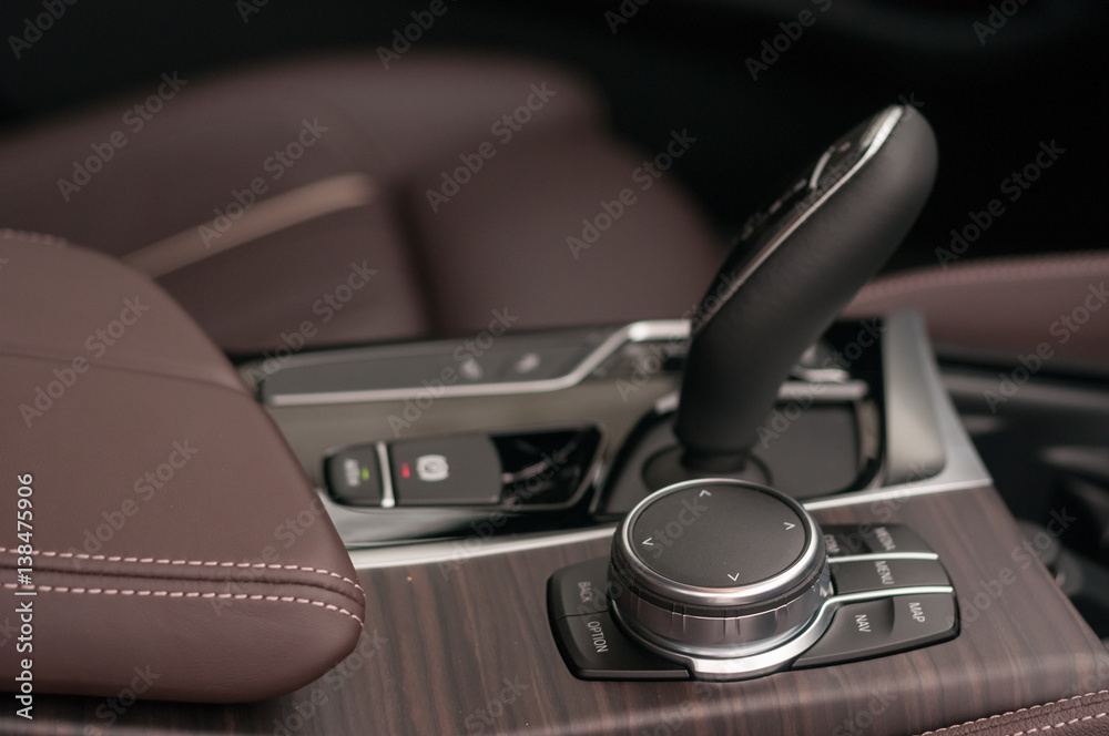 Automatic gear shift lever and infotainment system controls.