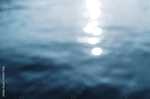 Water surface with ripples and sunlight reflections